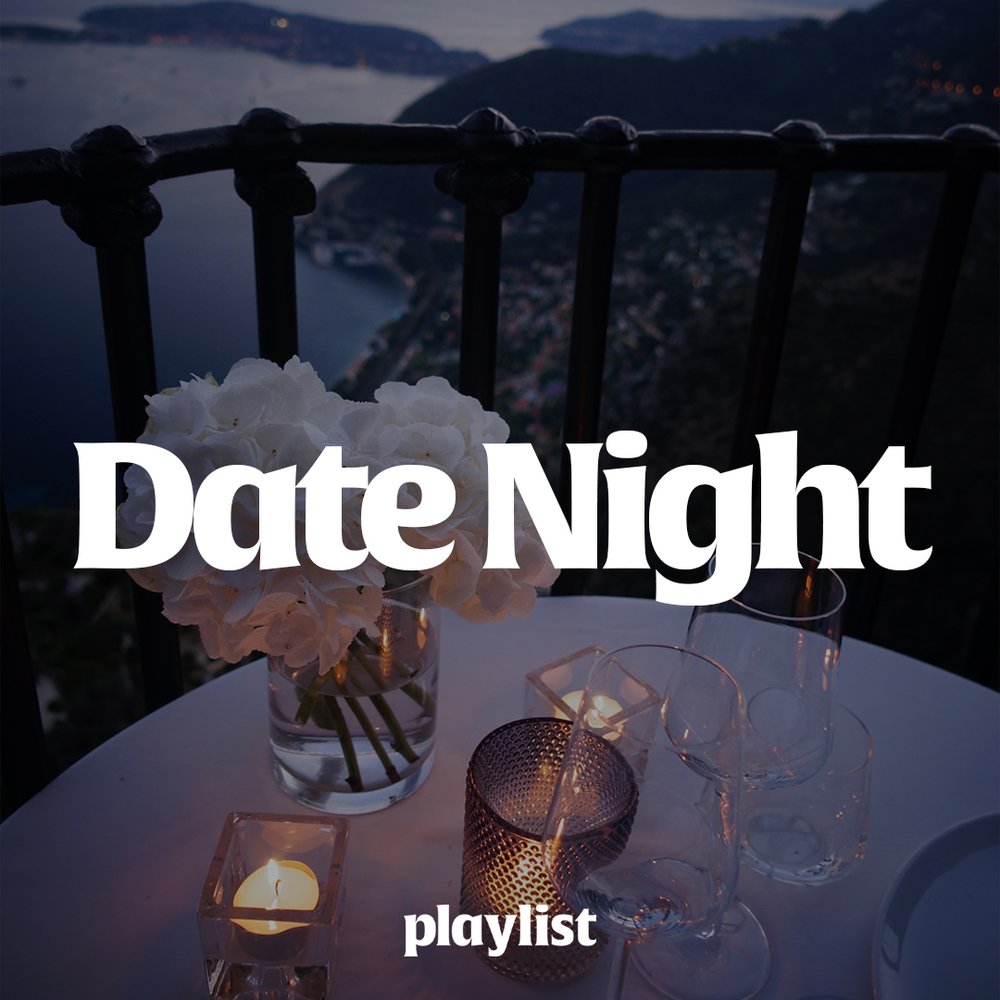 A romantic table setting with wine glasses on the table, overlooking a coastal view. White text reads, "Date Night" across the middle. 